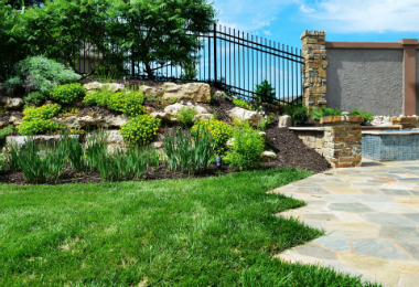 landscaped lawn with custom stone patio