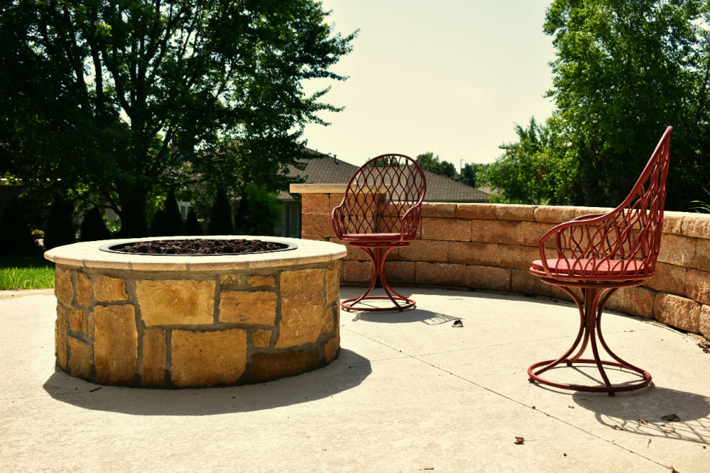 Stone patio and firepit with chairs