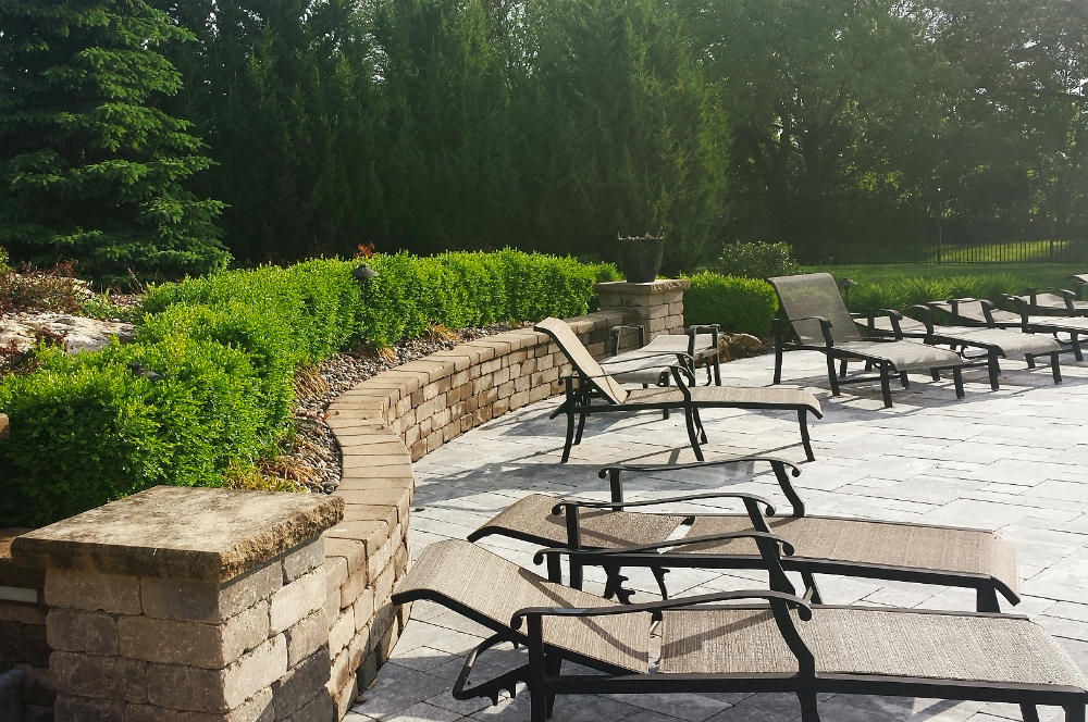 stone patio with bushes and landscaping