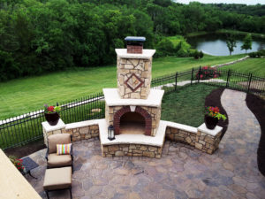 patio with stone fireplace and lounge chair