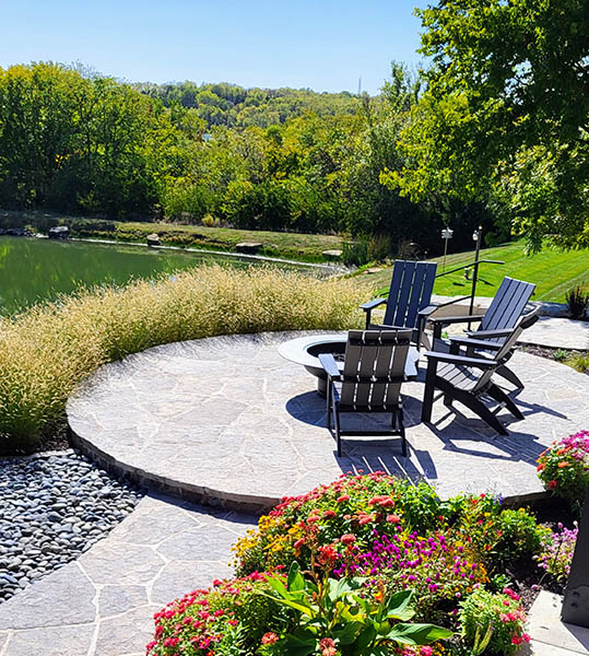 Circular patio with chairs and landscaping